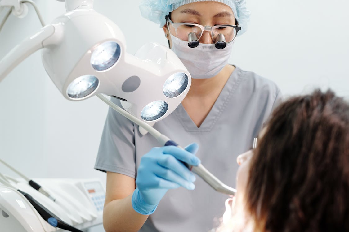 A dentist performing a laser dentistry treatment on a patient